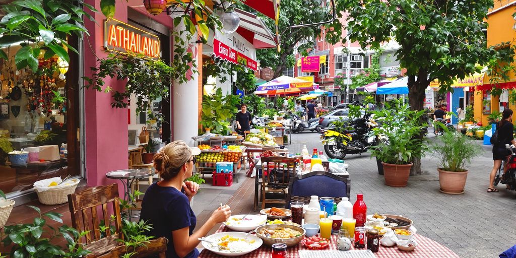 Solo traveler enjoying local cuisine in Thailand.