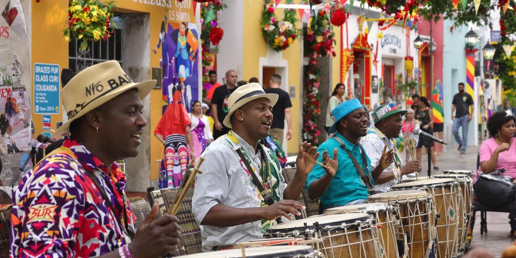 Afro-Brazilian musicians performing in colorful Salvador street.