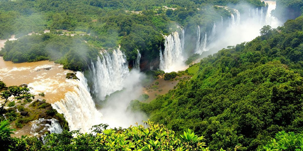 Iguazu Falls with lush greenery and cascading waterfalls.