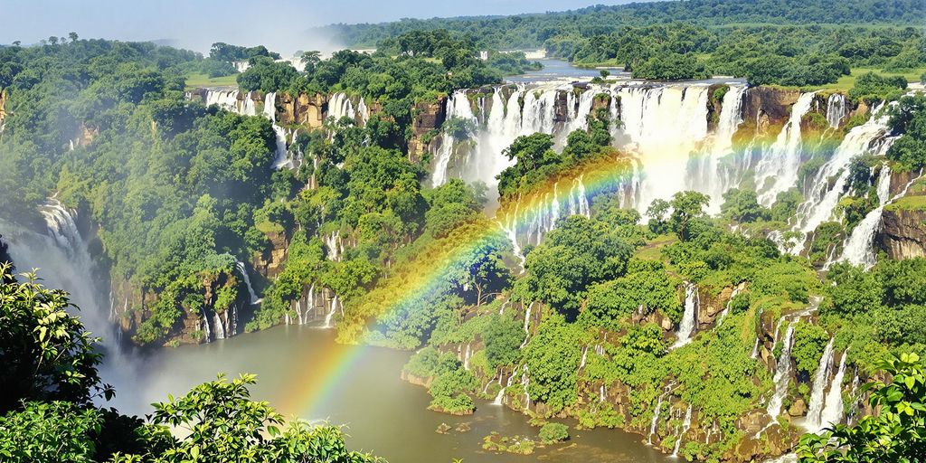 Iguazu Falls with cascading water and vibrant rainforest.