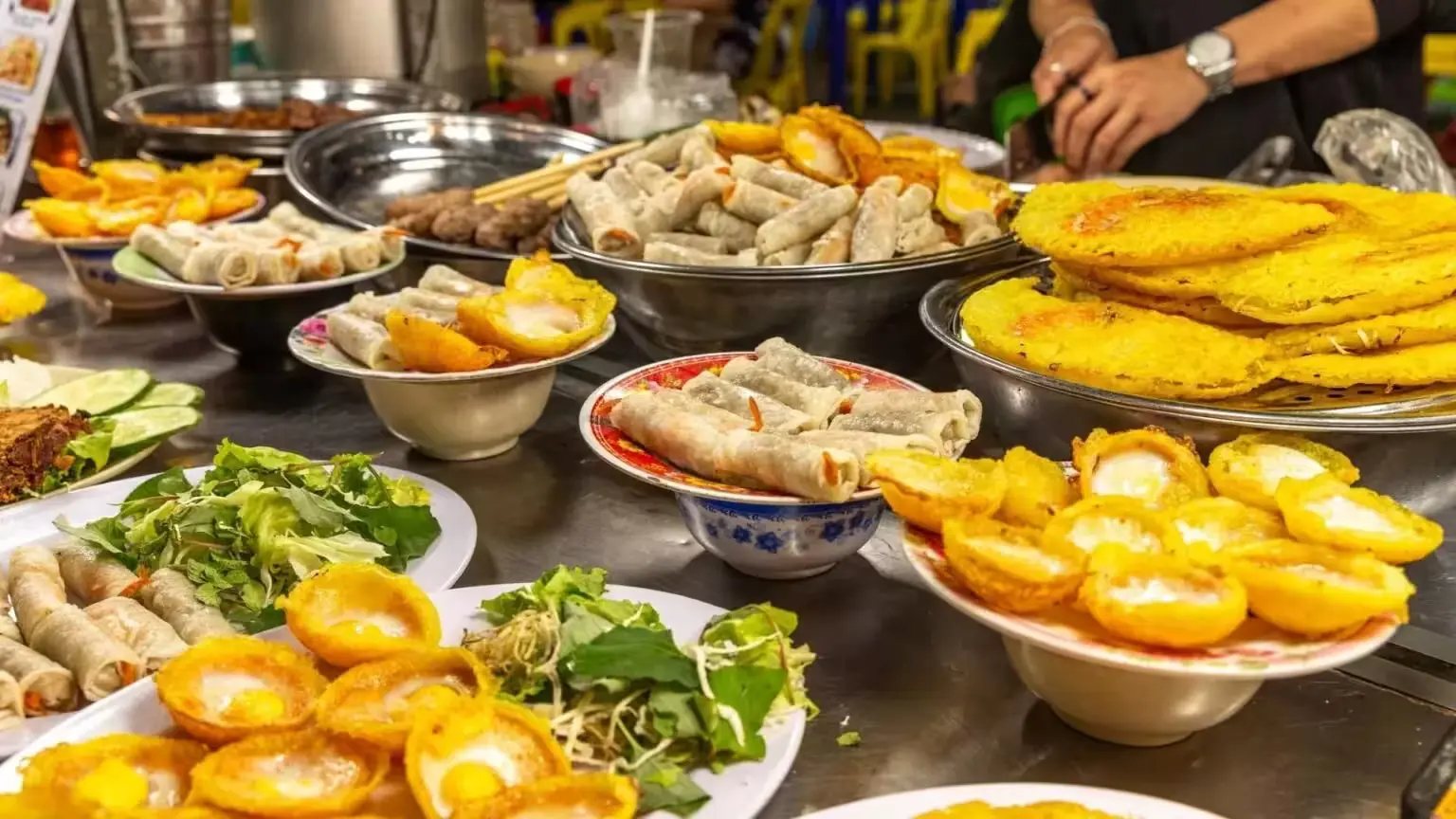 Vietnamese street food market with spring rolls and fried snacks