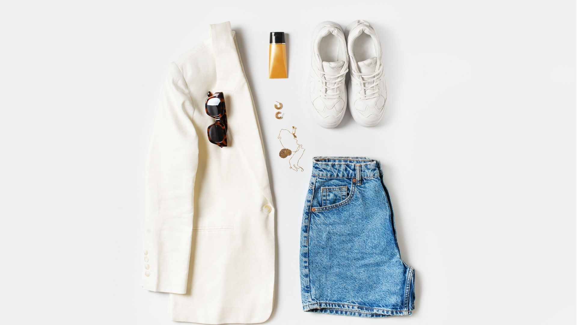 Chic outfit flat lay with sunglasses and sneakers