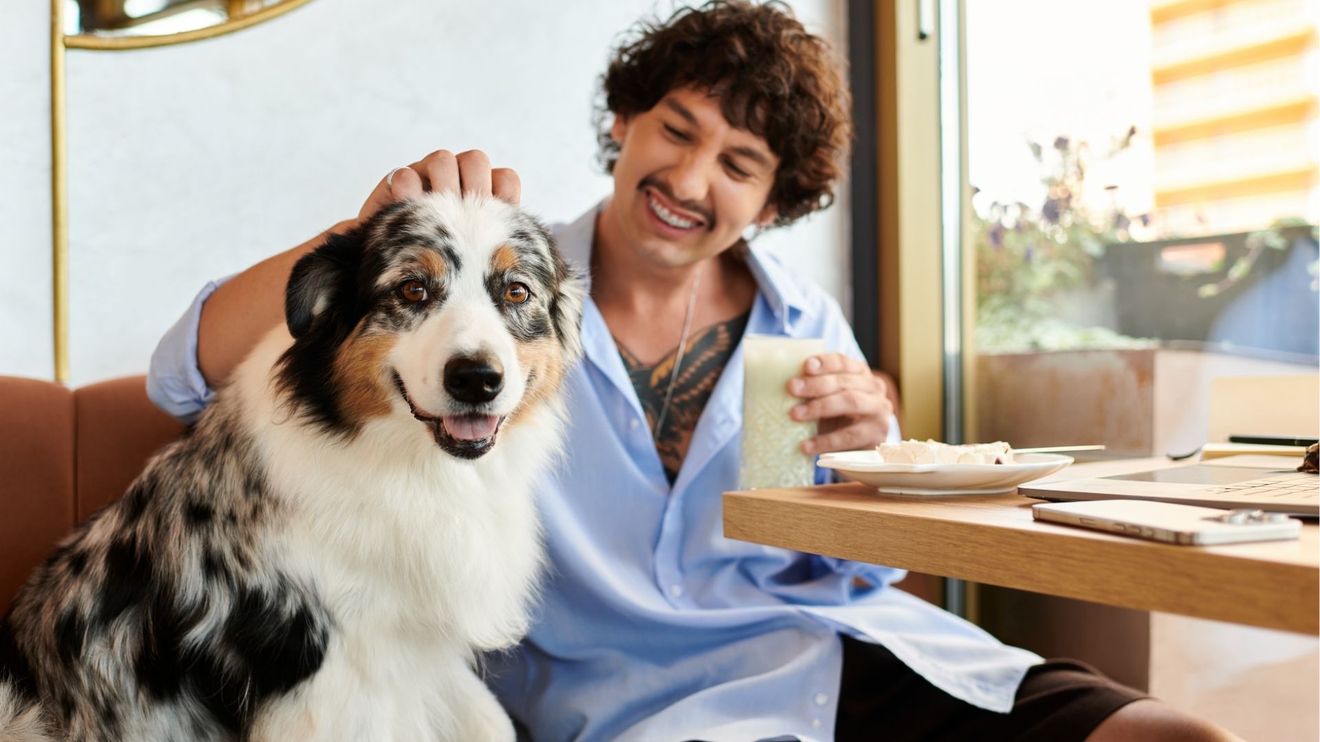 Charming young man enjoying a drink and pleasant company at a cozy cafe