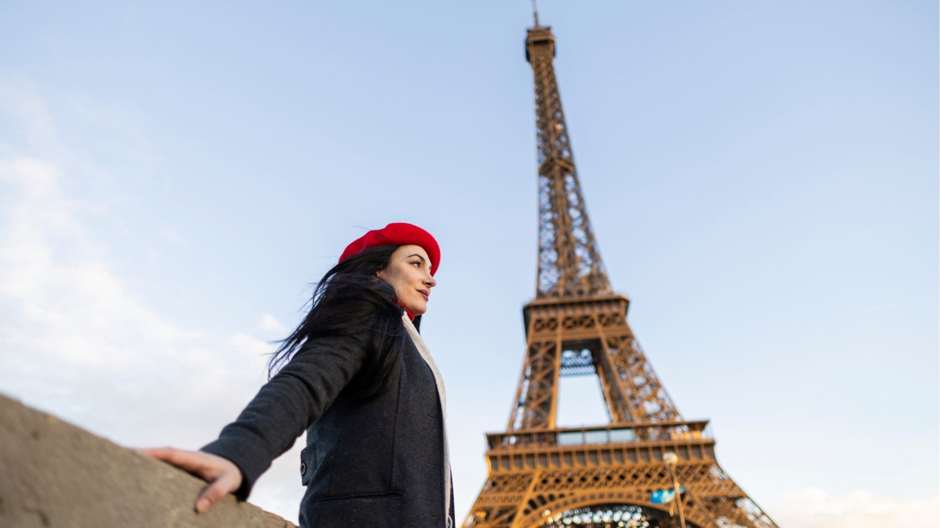 Woman in red beret at the Eiffel Tower in Paris