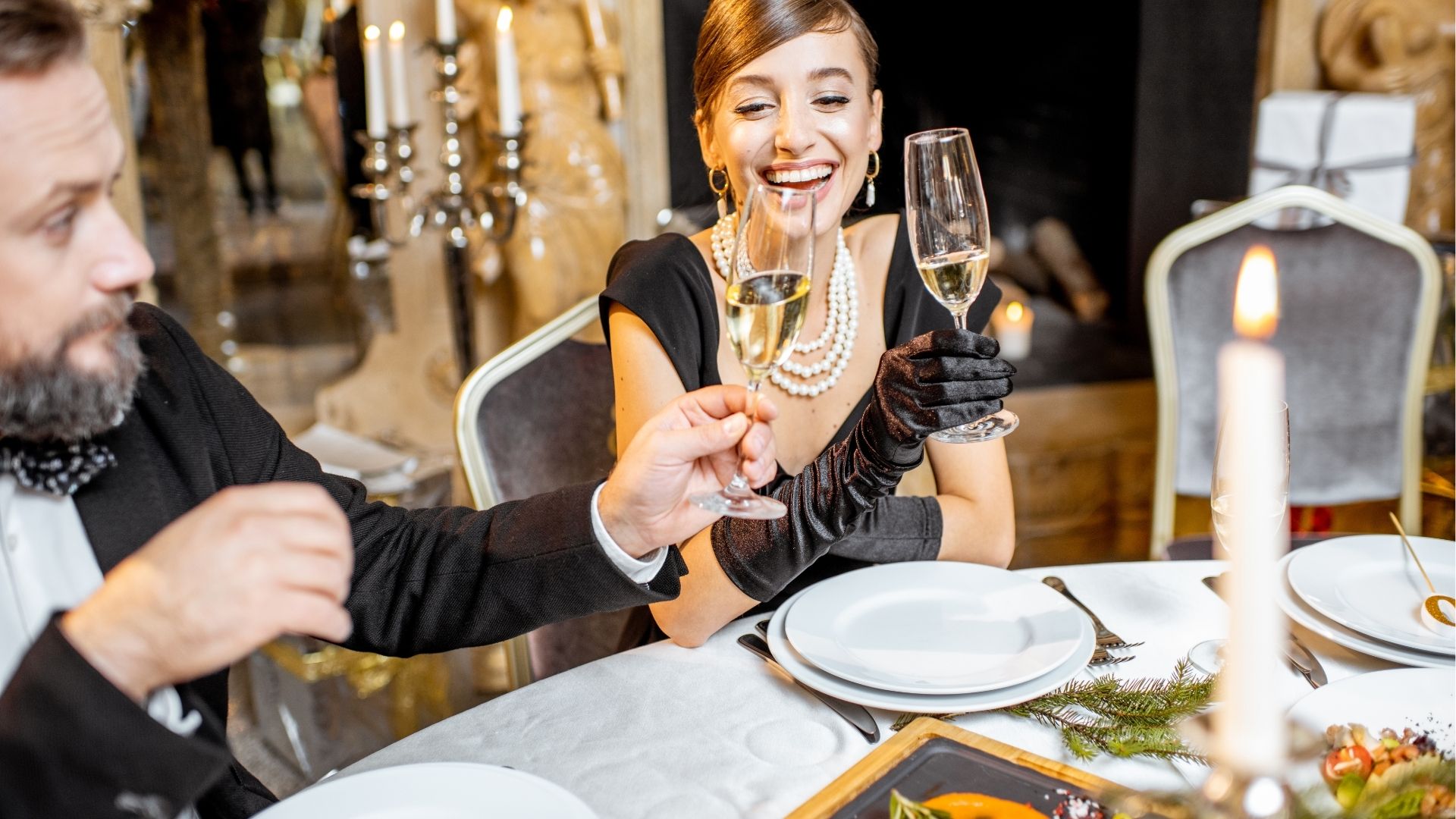 Elegant couple enjoying a fine dining experience with champagne in Bordeaux