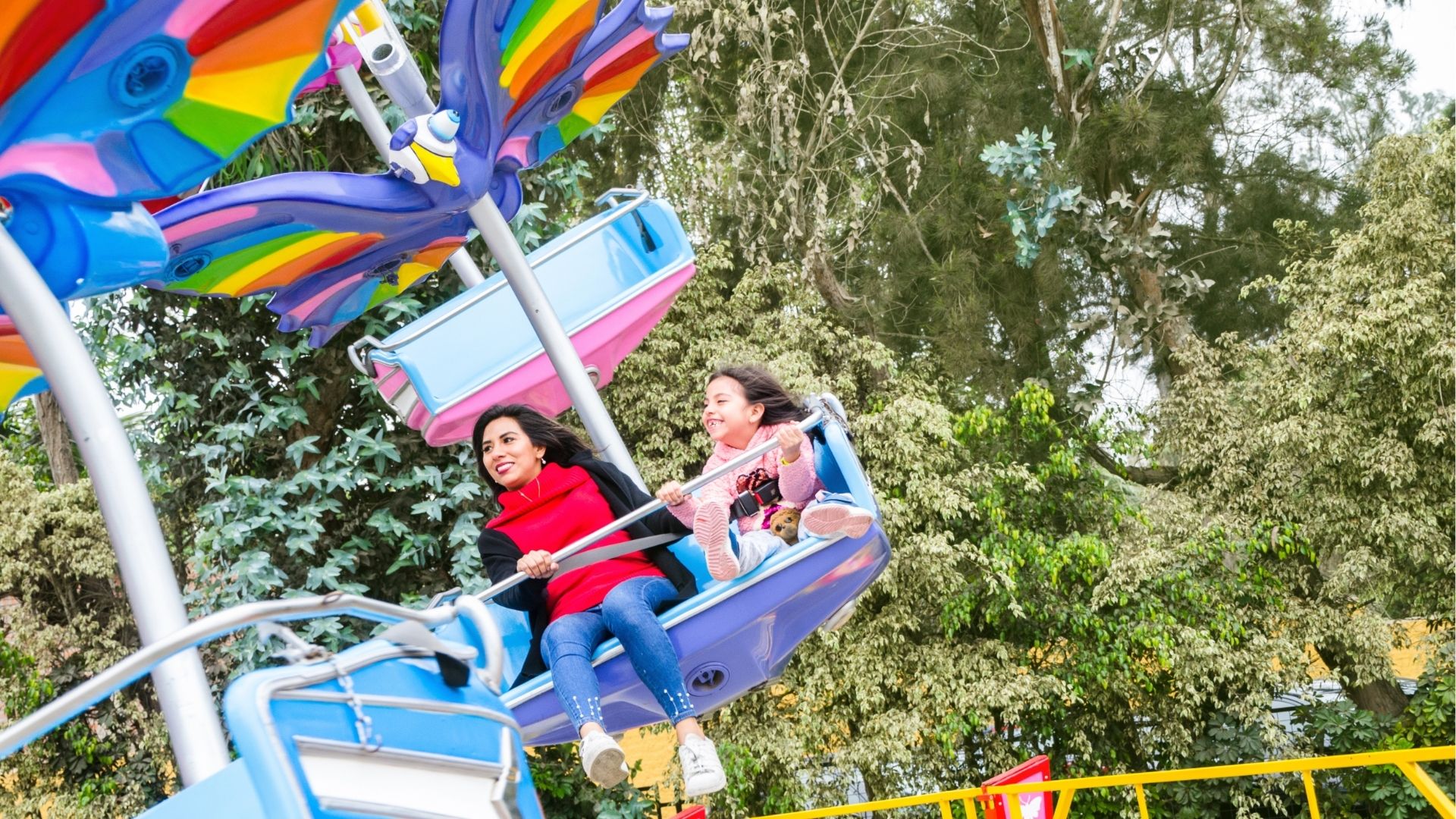 Mom And Daughter Having Fun And Smiling In An Amusement Park