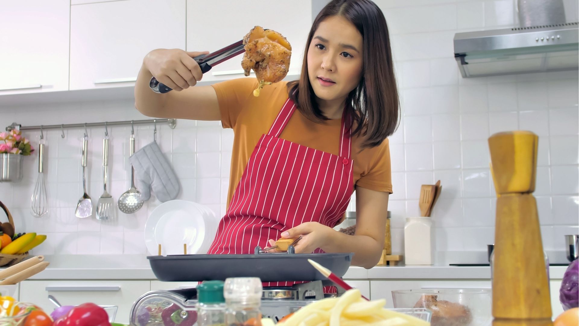 Young woman cooking in kitchen at home