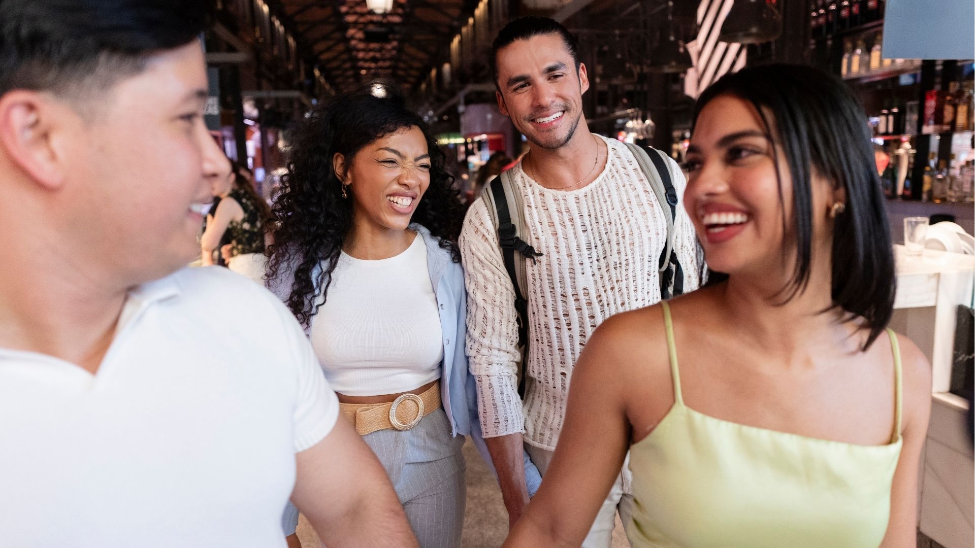 Friends walking, laughing, and enjoying market experience