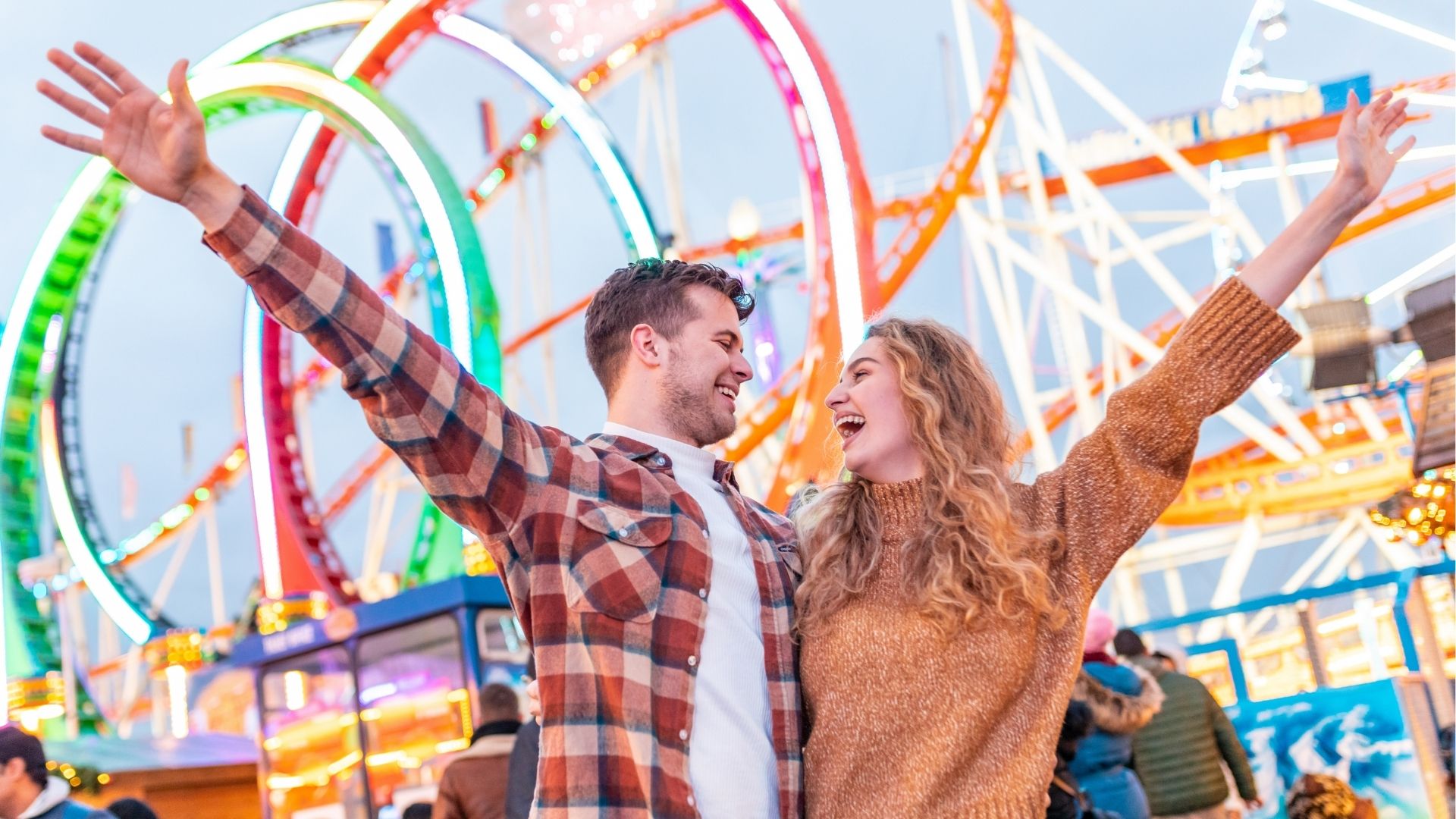 Happy couple having fun at amusement park in Venice