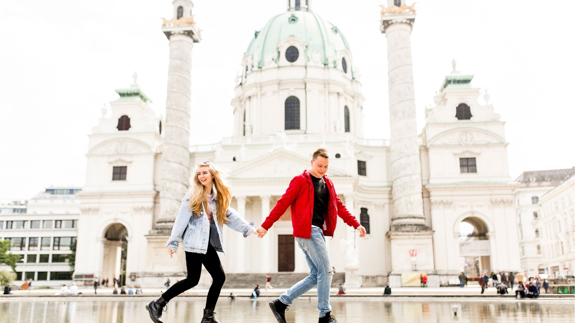 Travelers strolling by Karlskirche landmark in Austria
