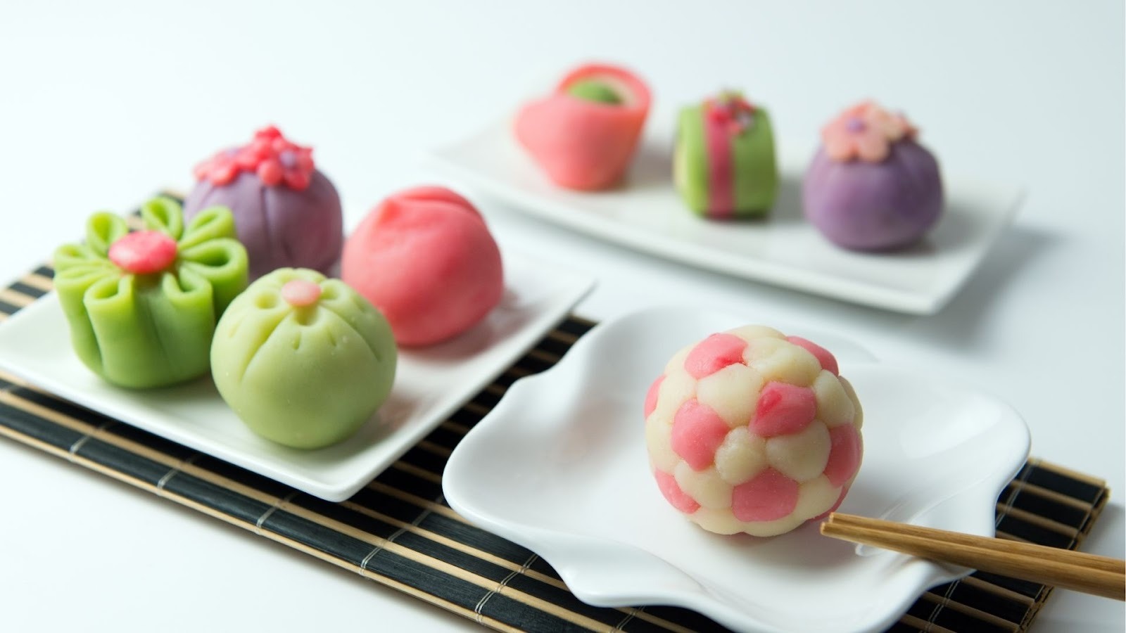 Colorful traditional Japanese desserts arranged on white plates
