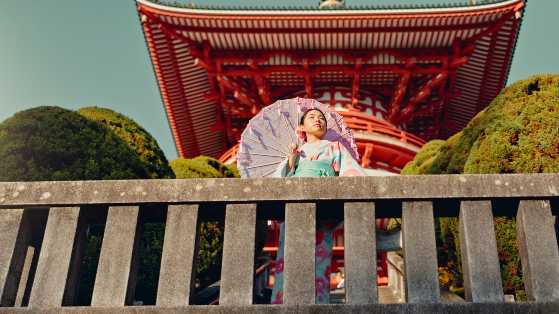 Japanese woman, umbrella and shinto temple with traditional clothes, culture and religion in sunshi