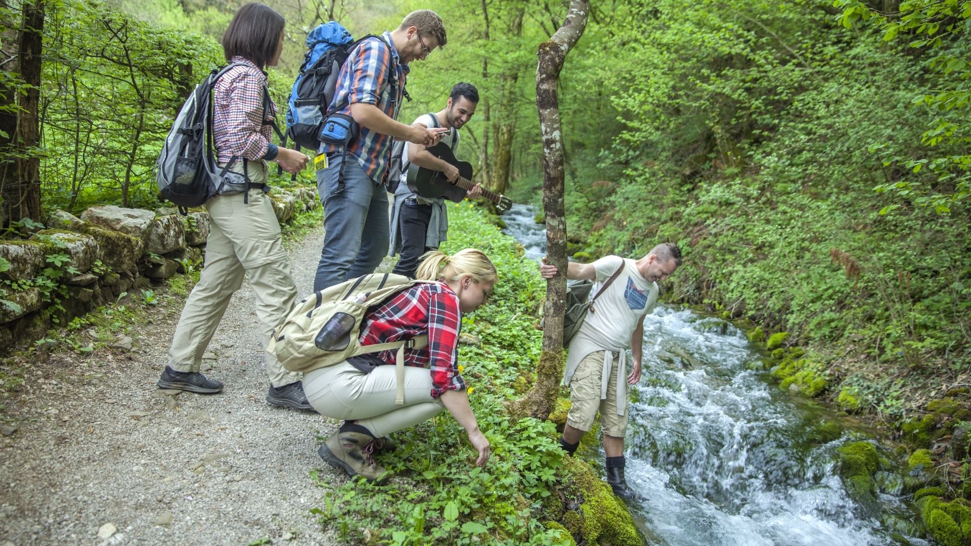 Group of friends in a forest by the river
