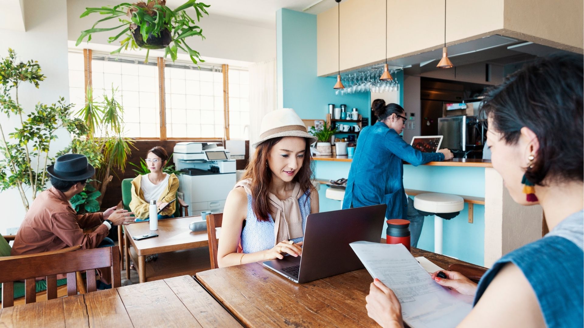 Group of professionals working on laptop in a co-working space
