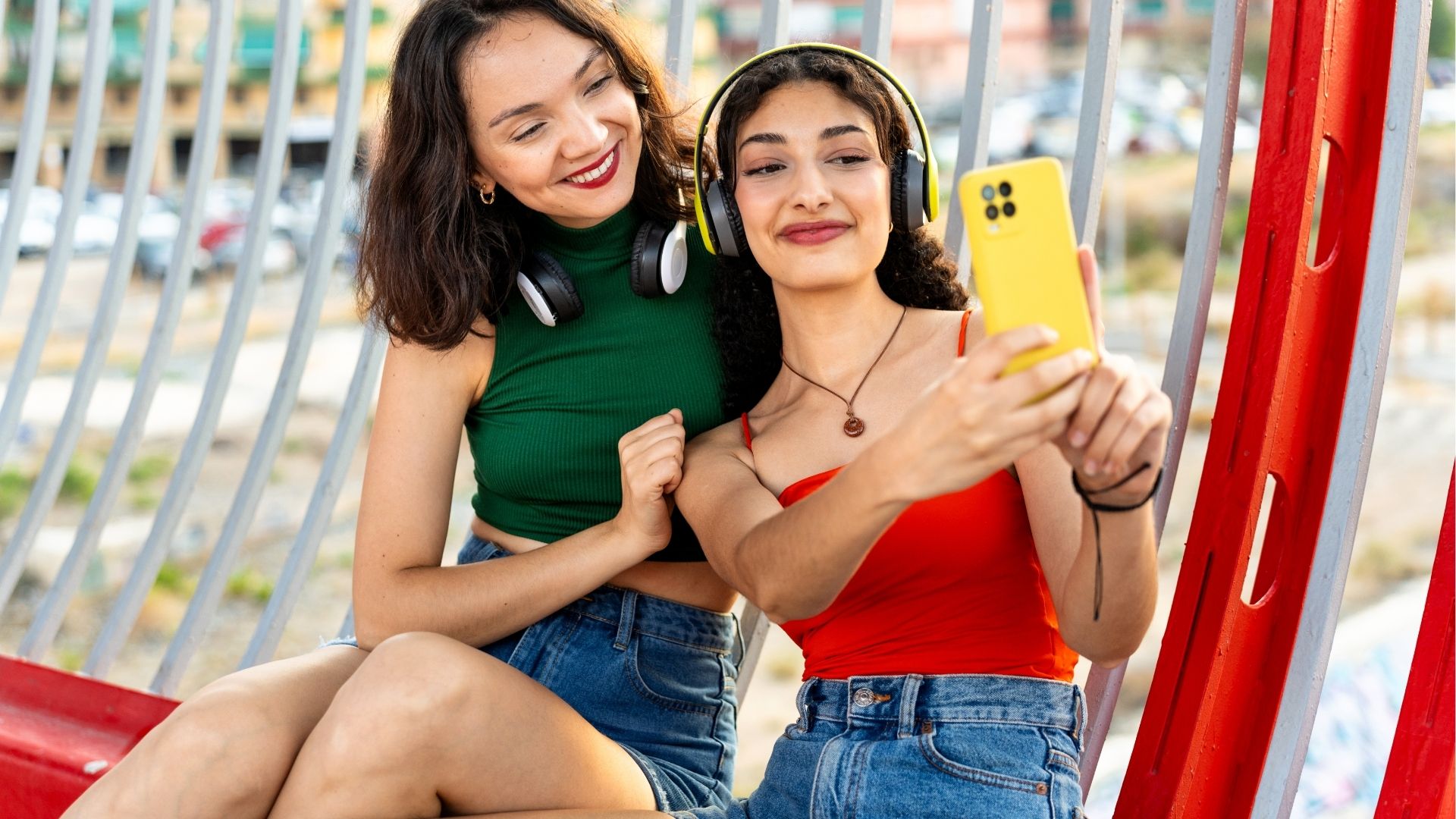 Friends taking a selfie on a smartphone, representing easy travel connectivity with eSIM