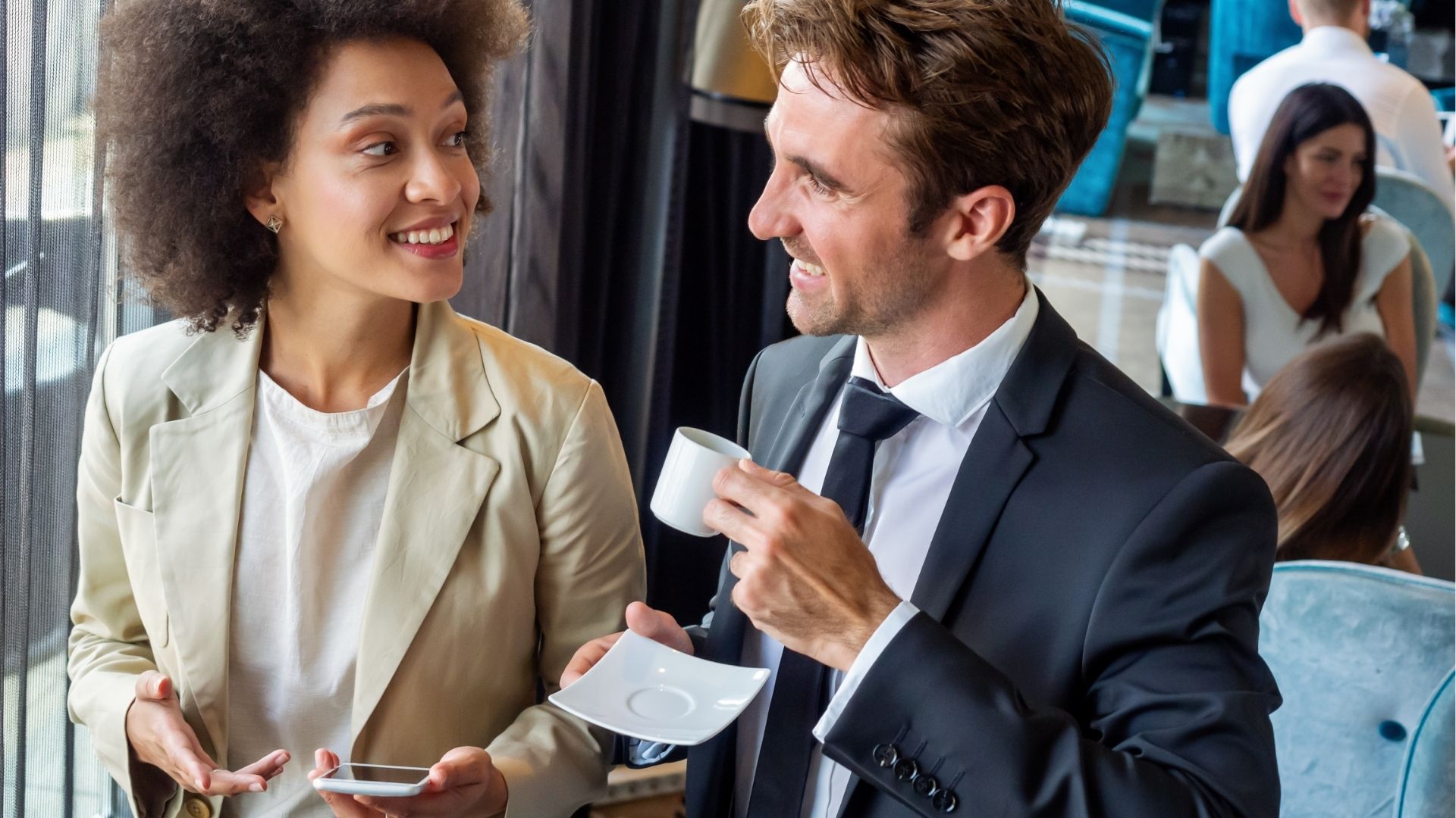 Young couple of professionals chatting during a coffee break

