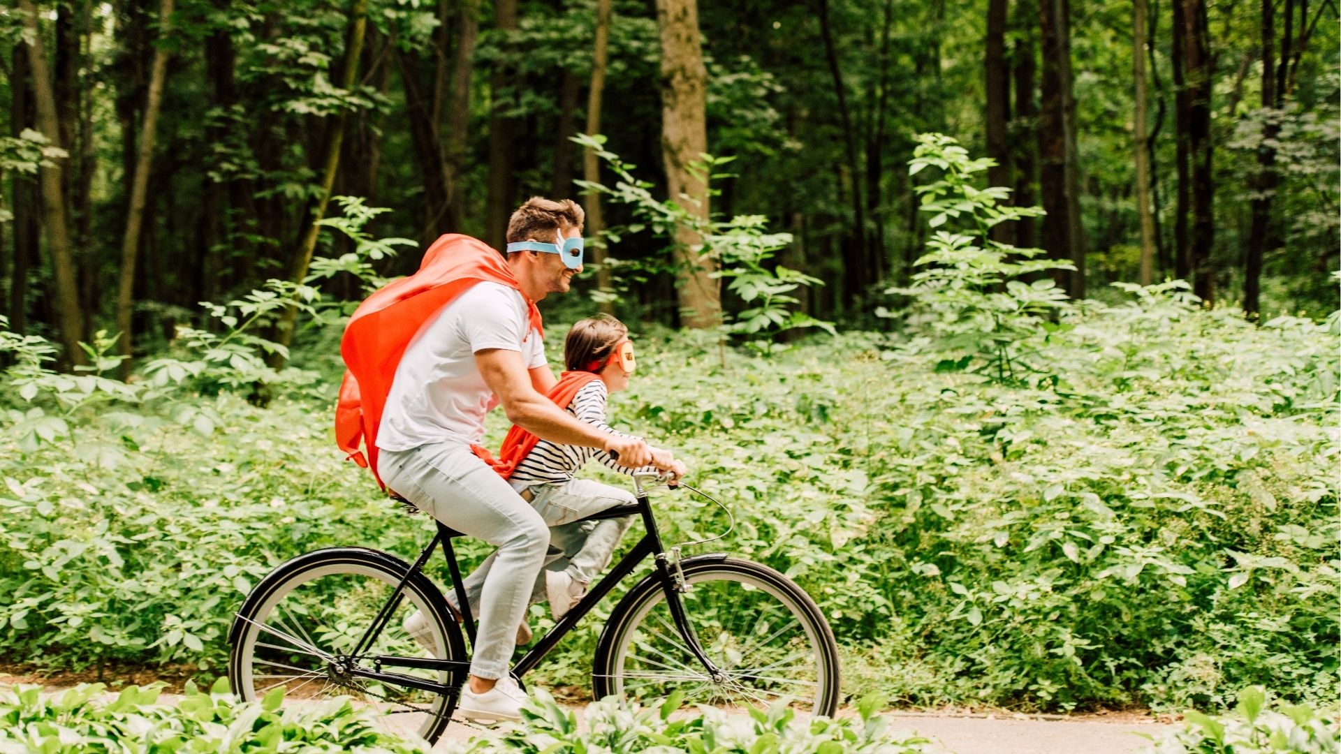 Father and Son riding bicycle around forest
