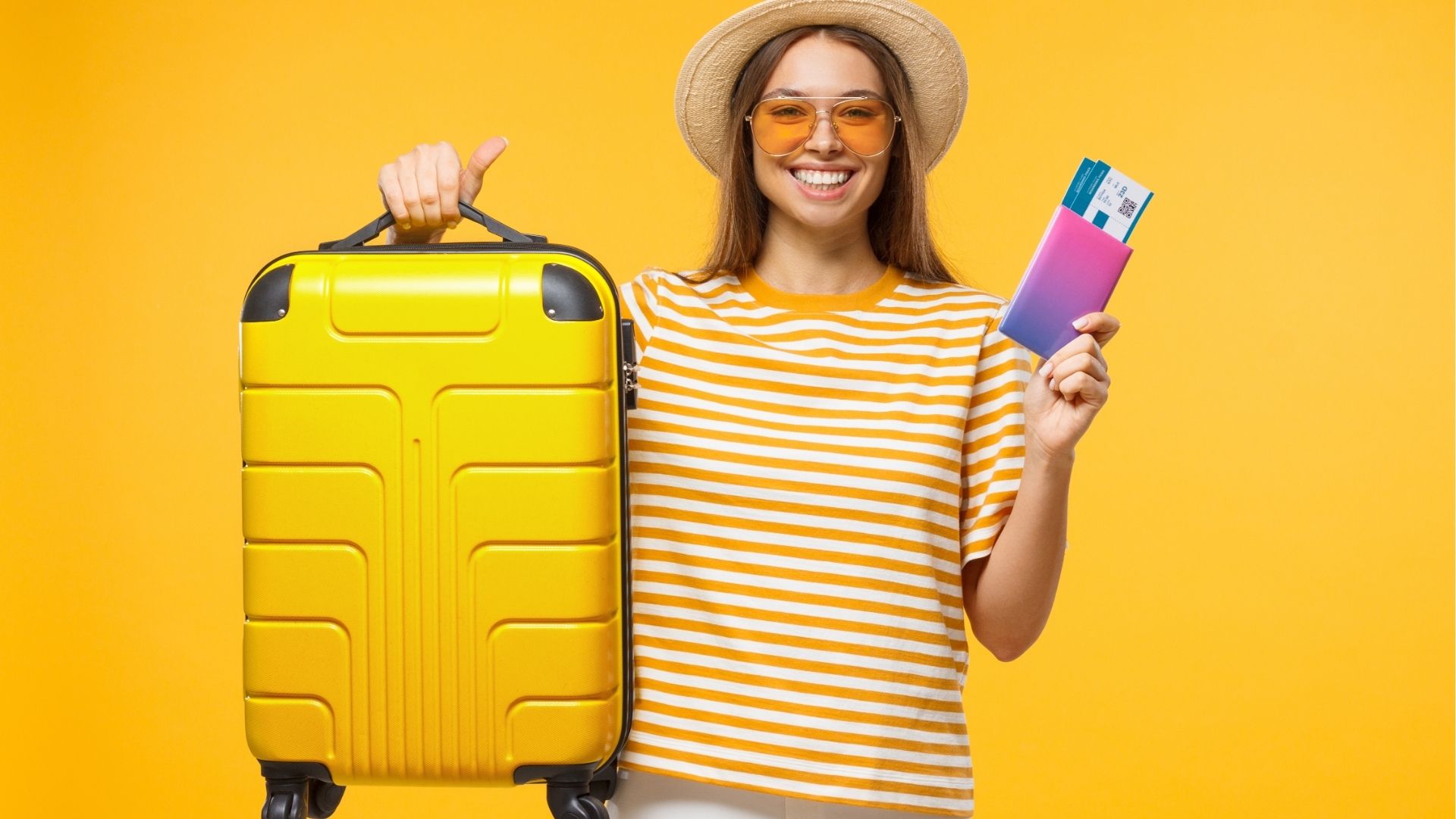 Woman tourist holding large suitcase and passport with flight tickets
