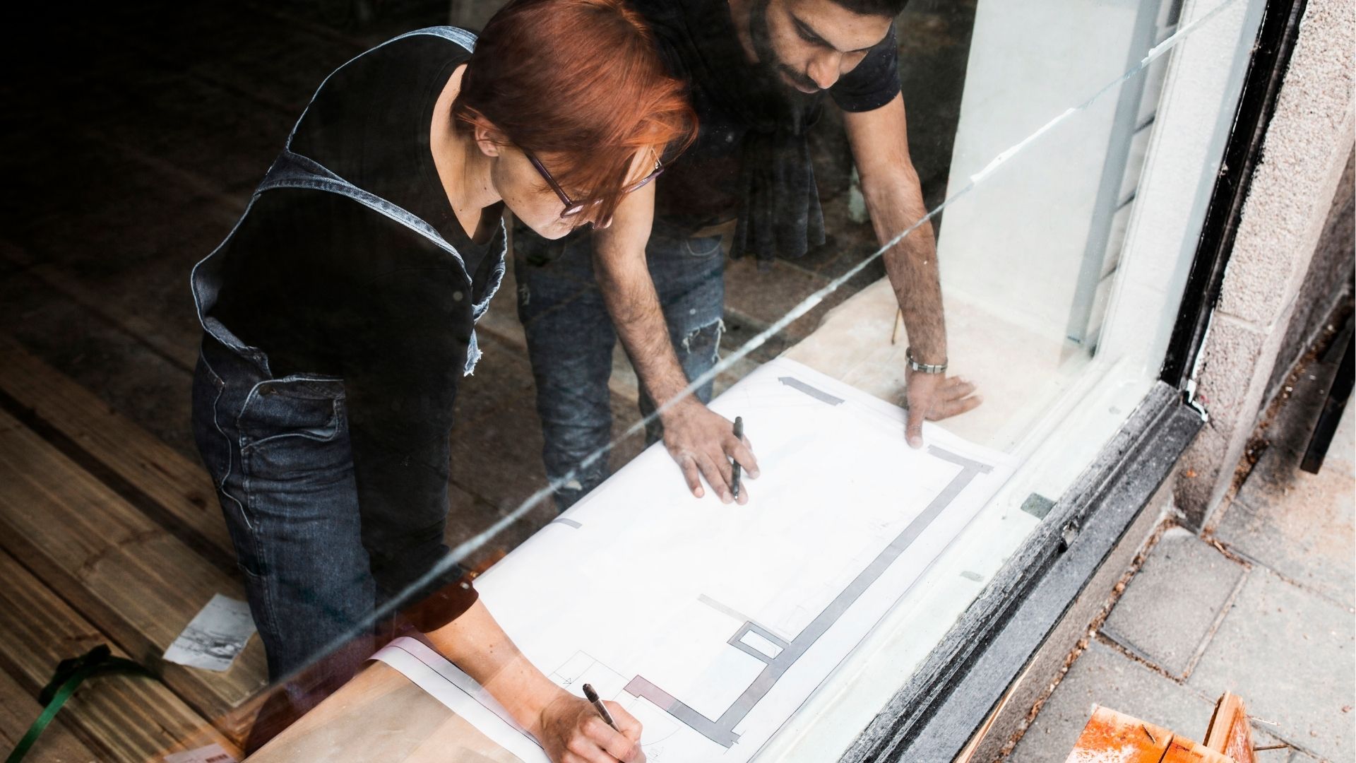 Man and woman discussing blueprint