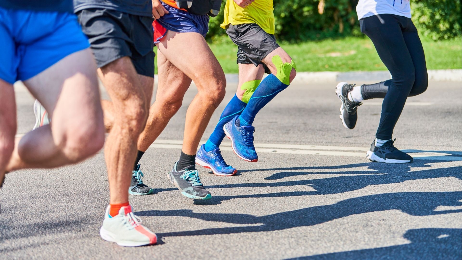 Marathon runners on city road.