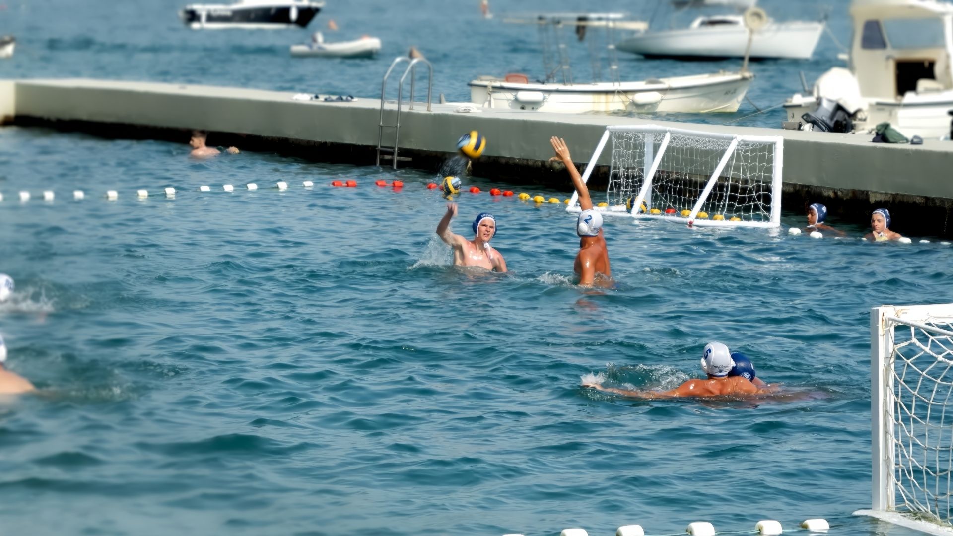 Slow motion of water polo male team having open-air tournament on sea