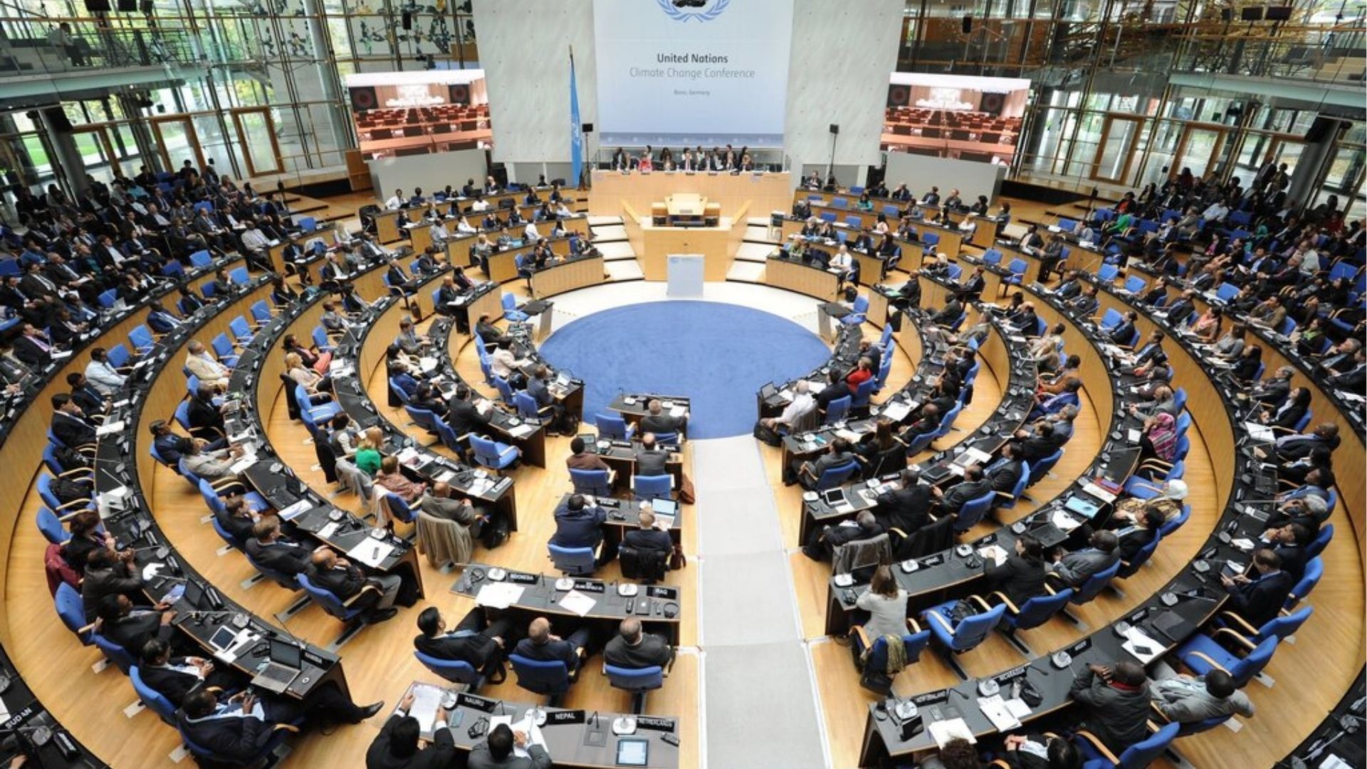 Delegates seated inside a large United Nations climate conference hall during an international summit