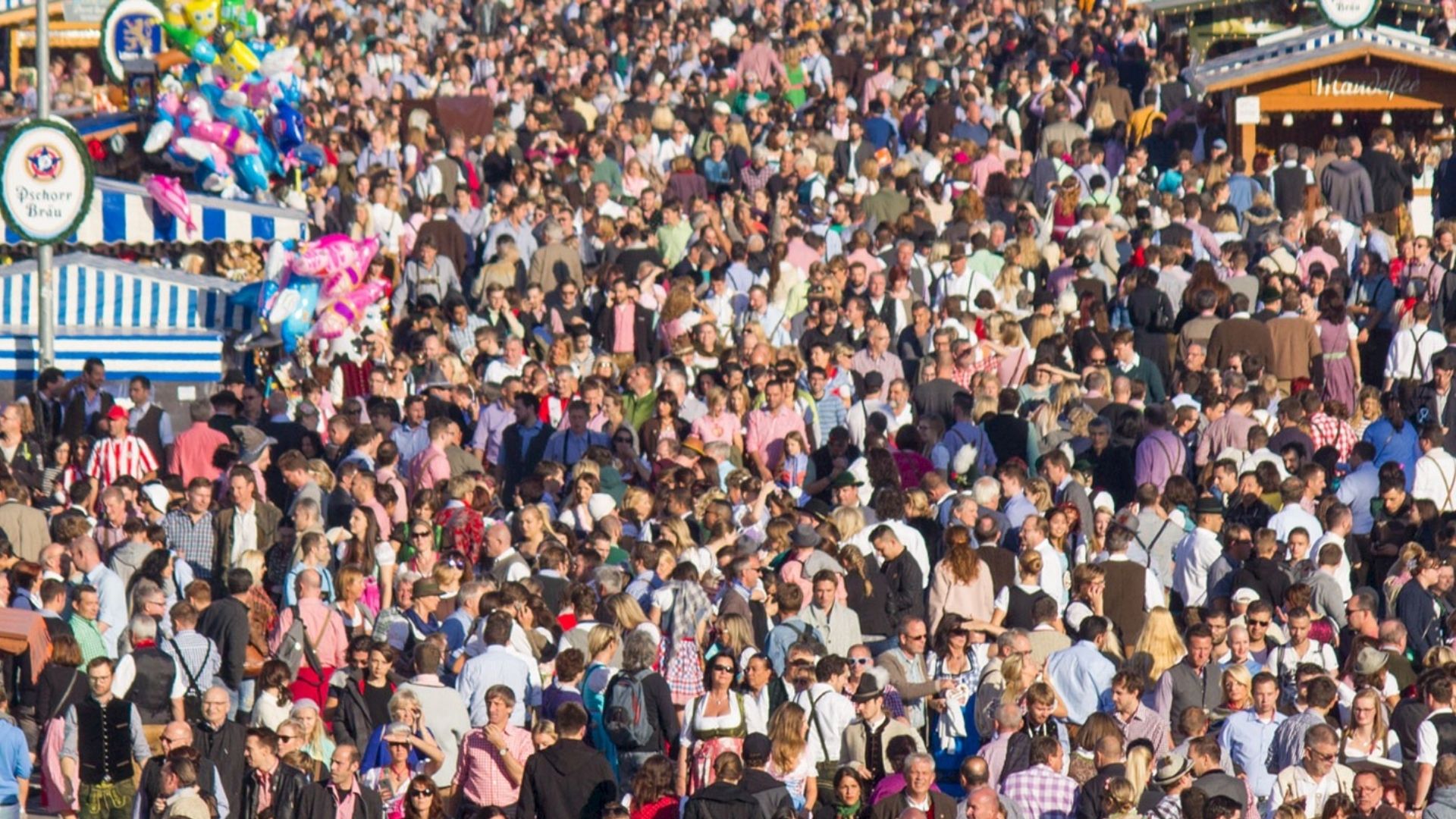 Large crowd attending Oktoberfest in Munich with traditional tents and festival atmosphere