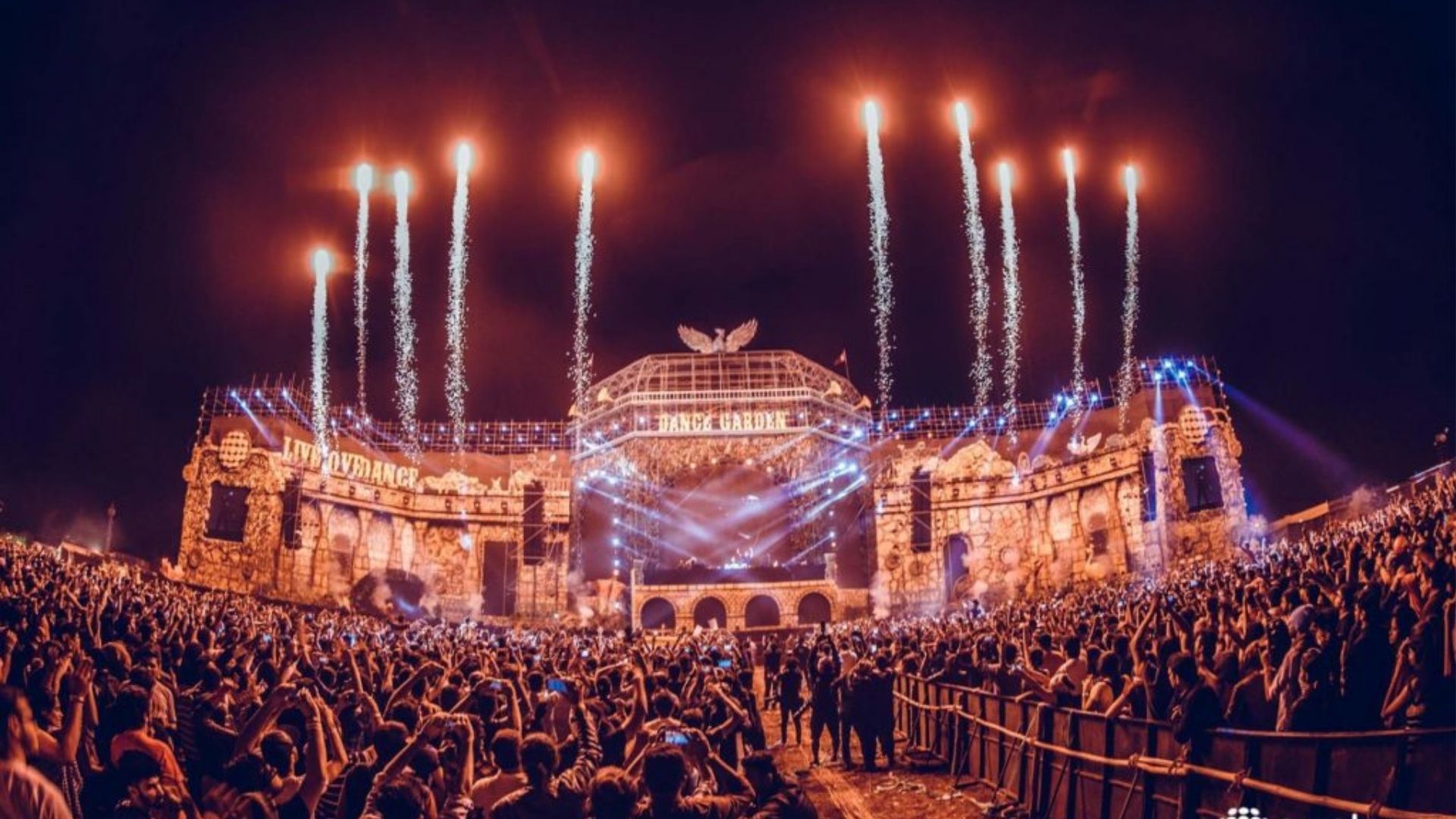Crowd dancing at a beachside electronic music festival in Goa during peak winter season