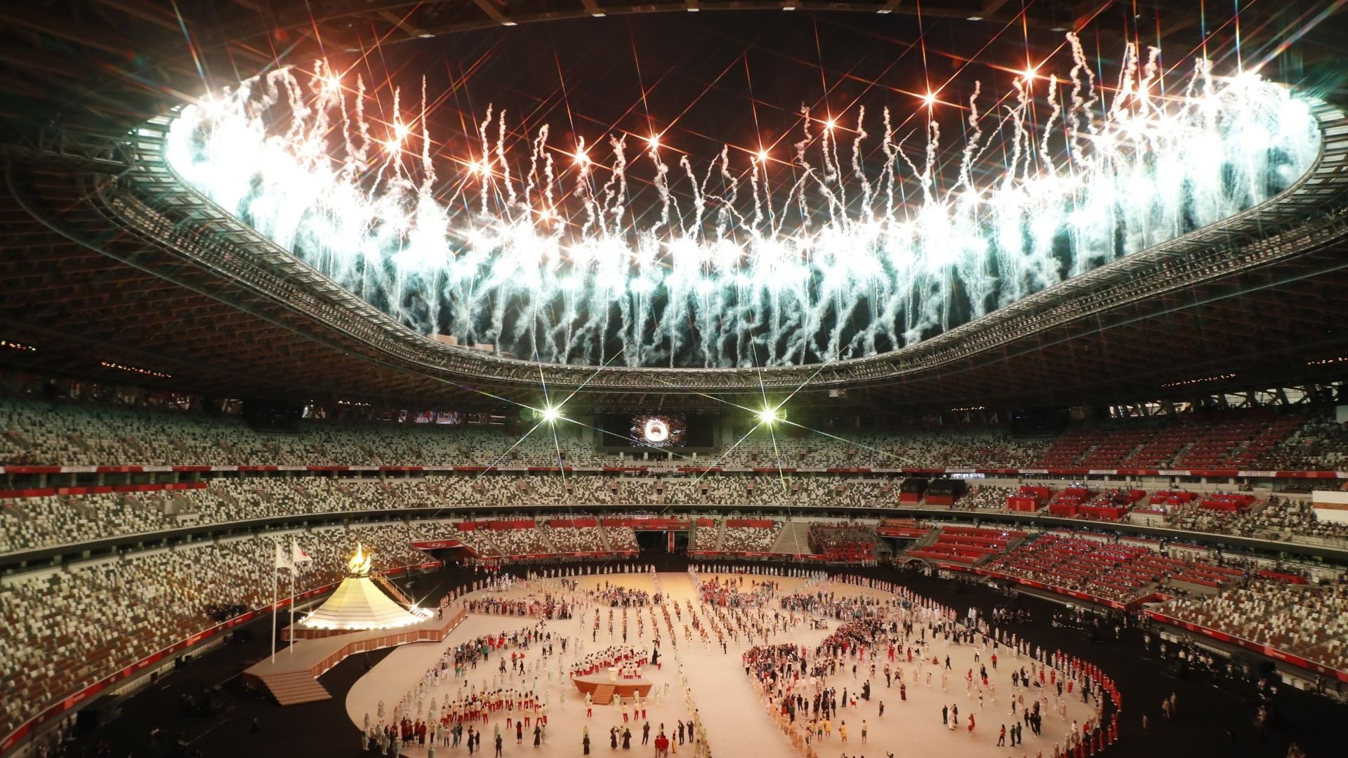 International sports opening ceremony inside Tokyo stadium with fireworks and spectators