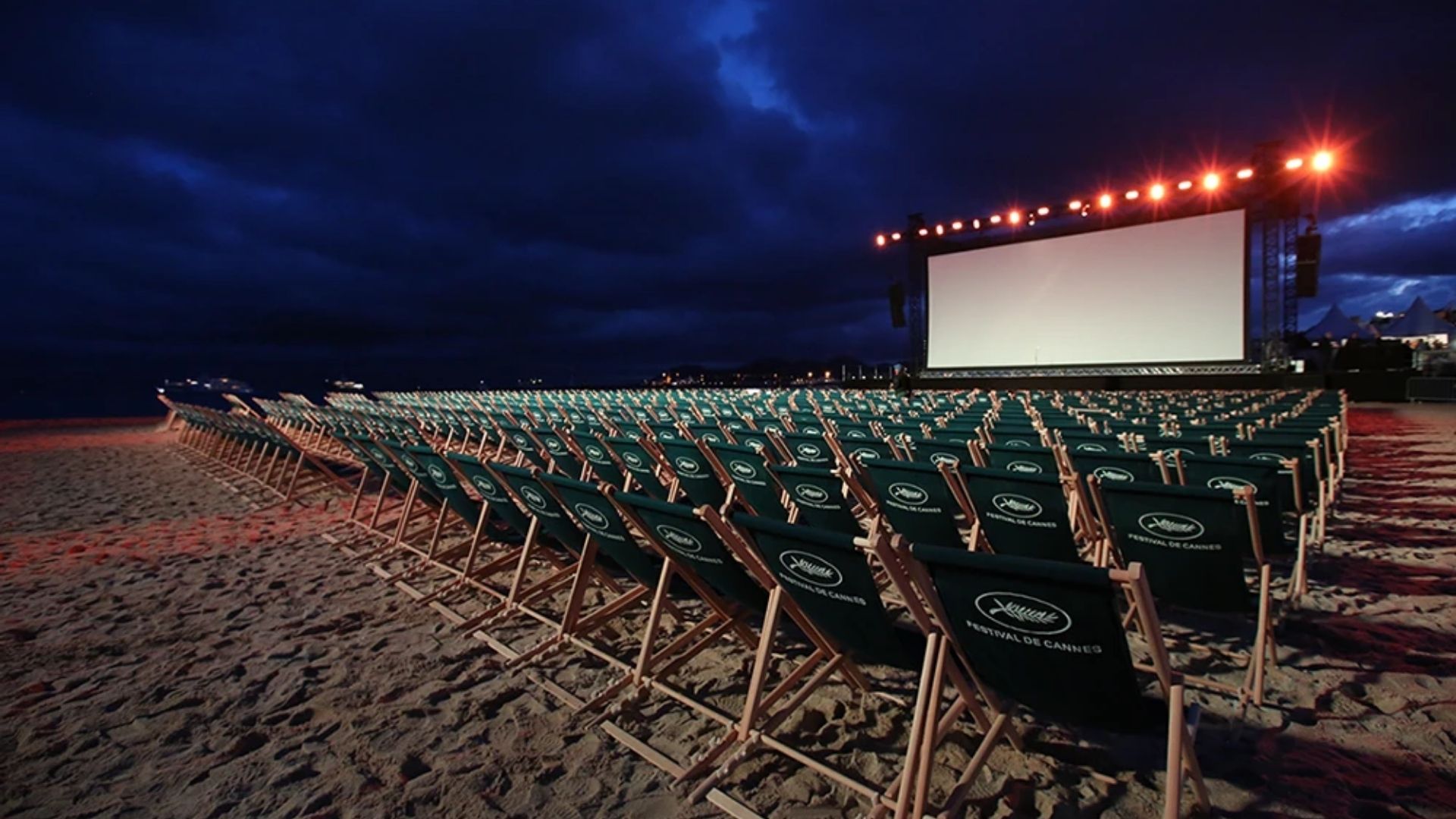 Outdoor beach cinema seating at Cannes Film Festival night screening on the shore