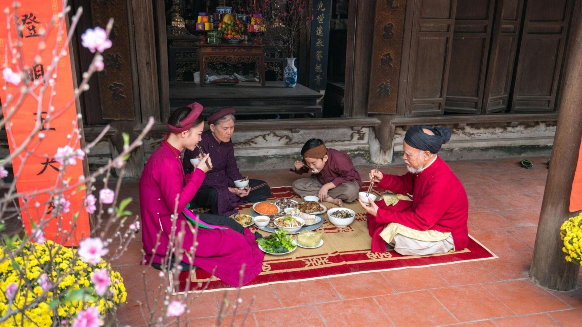 Vietnamese family celebrating Tet Lunar New Year with traditional meal and ancestor altar