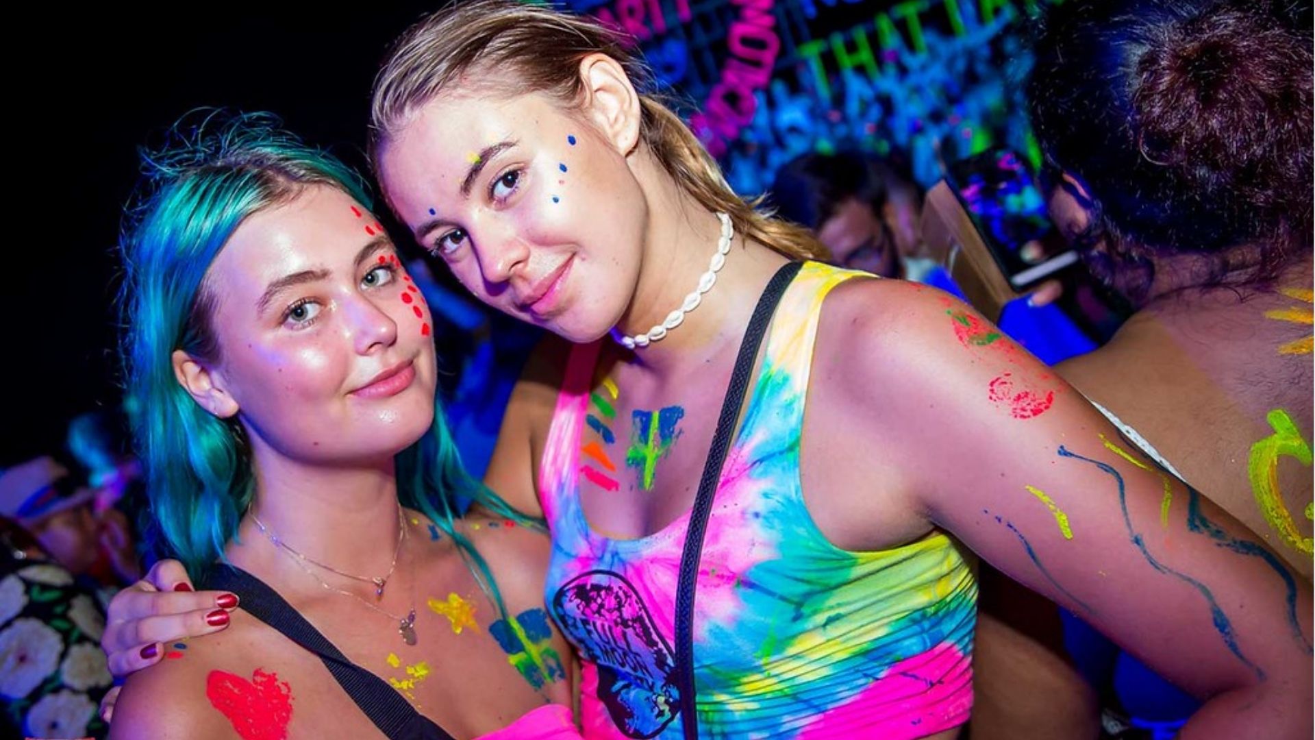 Tourists enjoying UV paint and nightlife at Koh Phangan Full Moon Party