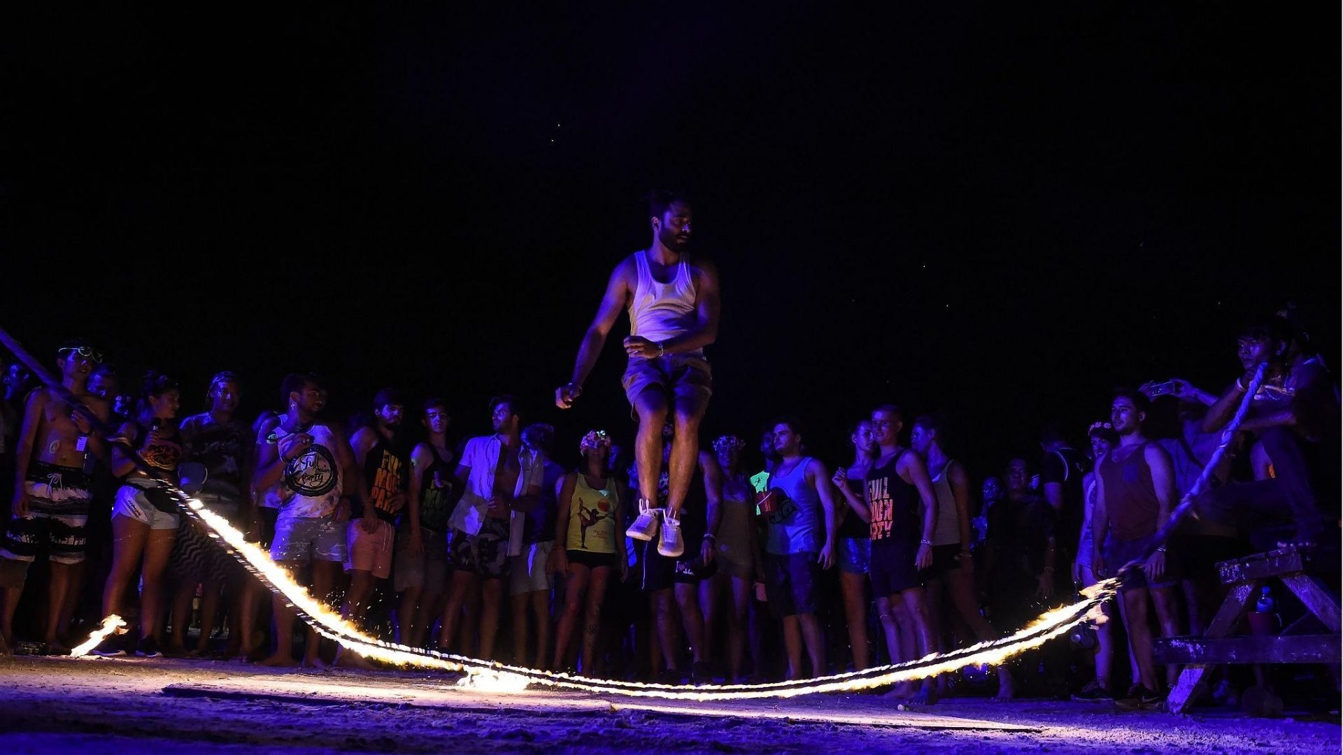 Visitors watching fire dance performance at Thailand Full Moon Party