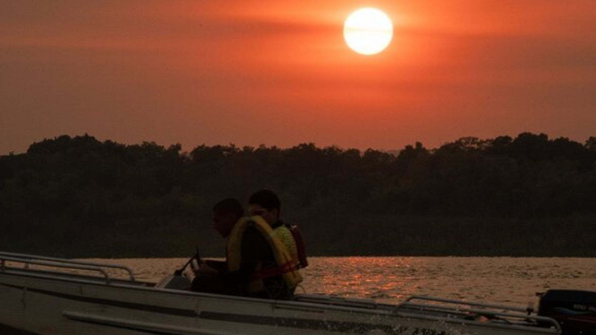 Boat ride on Paraguay river during sunset with travelers enjoying scenic views
