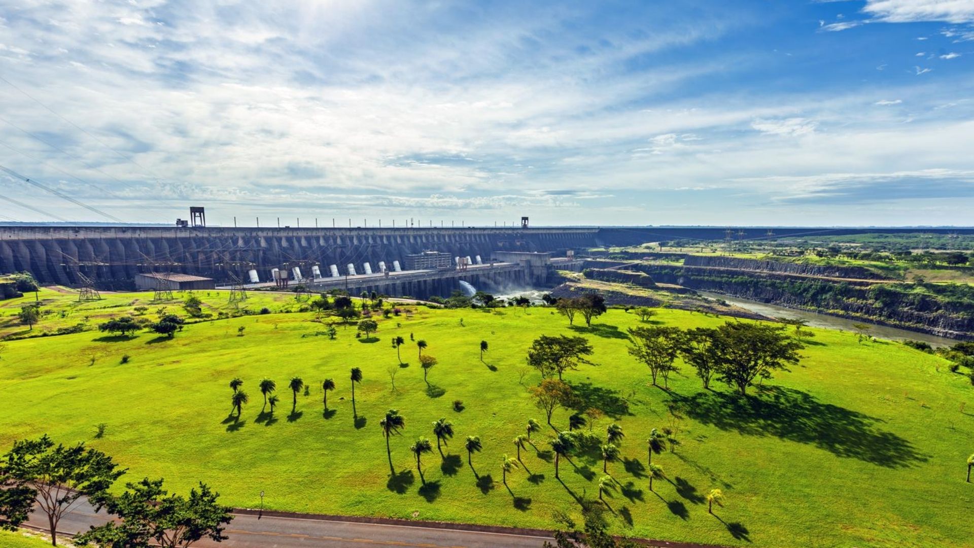 Aerial view of Itaipu Dam with green landscape and road in Paraguay