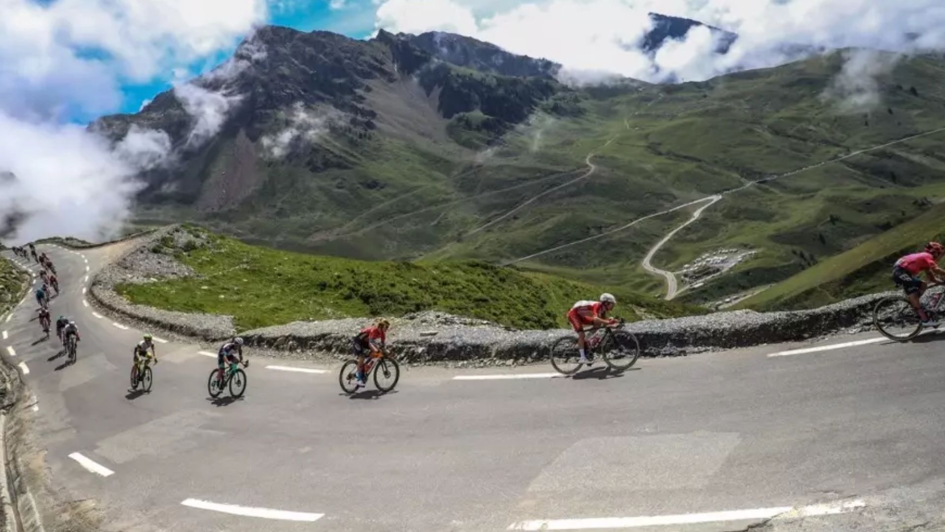 Cyclists riding through mountain roads during a scenic stage of the Tour de France race
