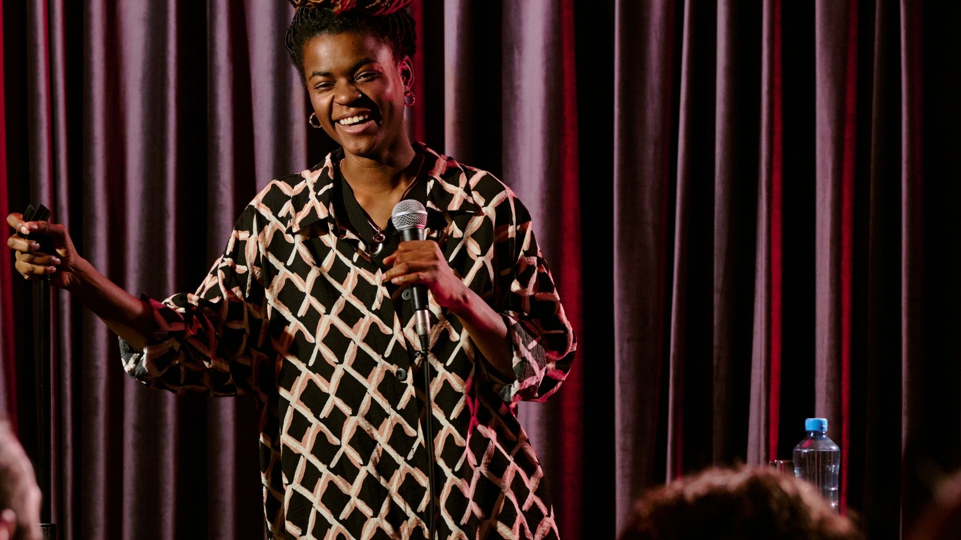 Stand-up comedian performing on stage with microphone during a live comedy show in Melbourne